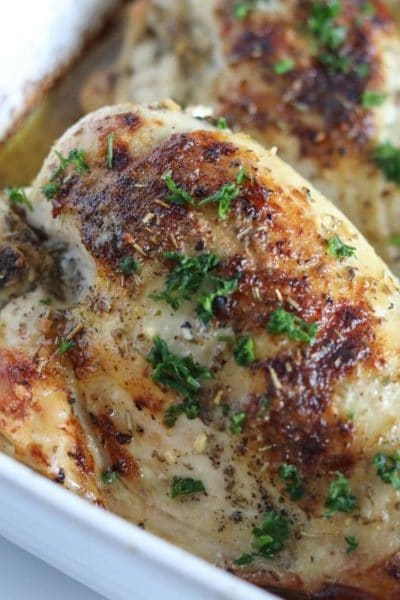 baked chicken in a white casserole dish.