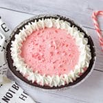 close shot of peppermint pie with candy canes in background